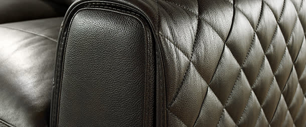 Stiched black leather sofa arm