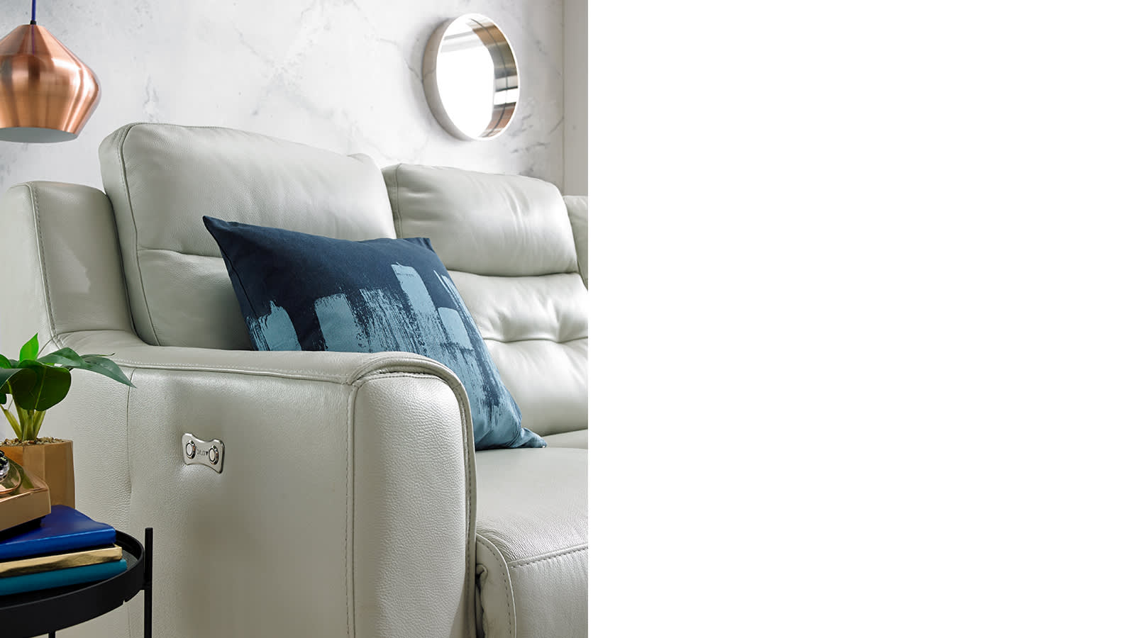 White leather sofa with blue cushion