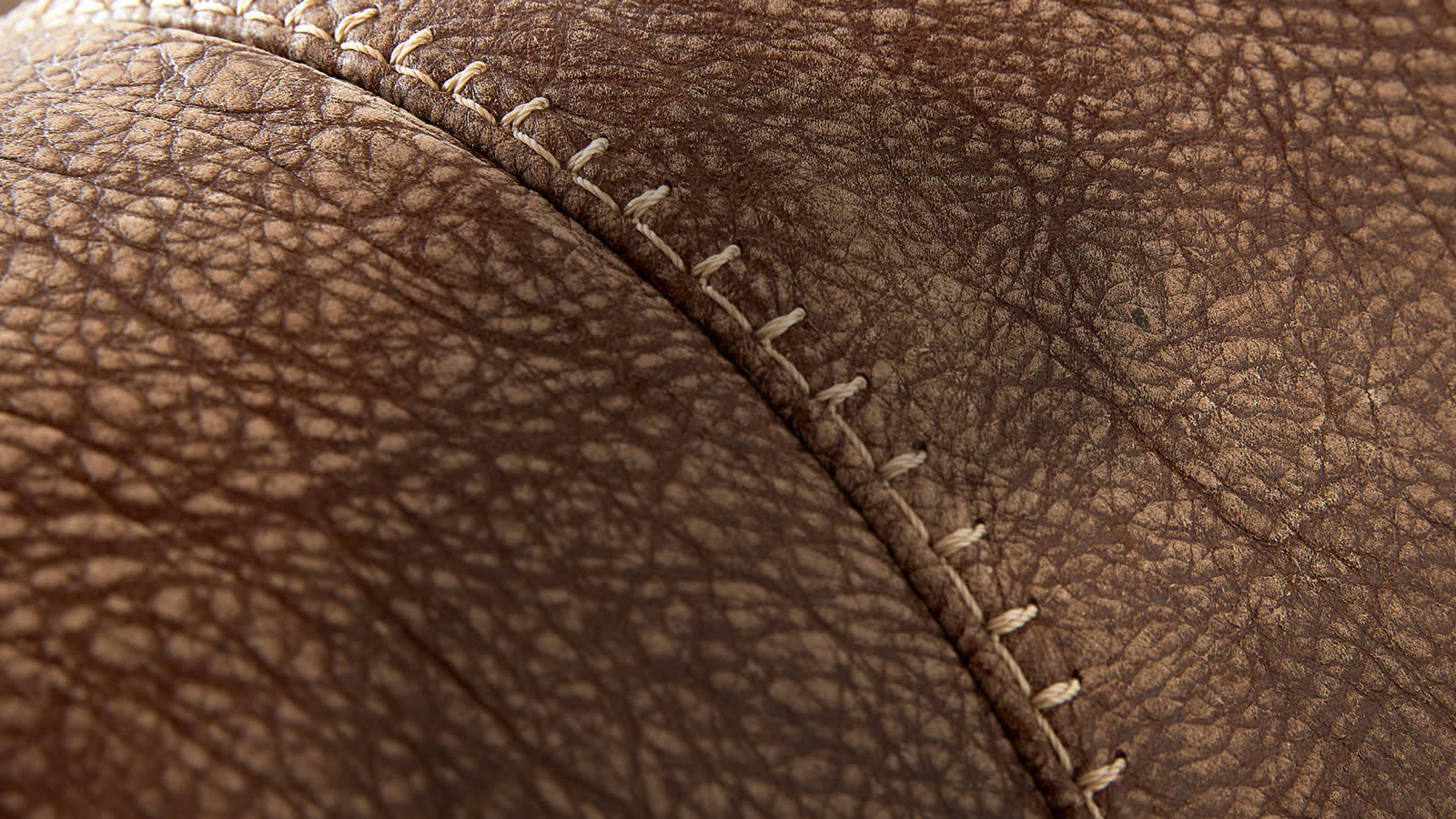 Closeup of brown leather sofa stitching