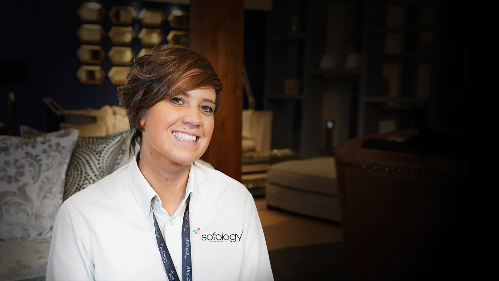 Female Sofology retail store manager sat on sofa in store