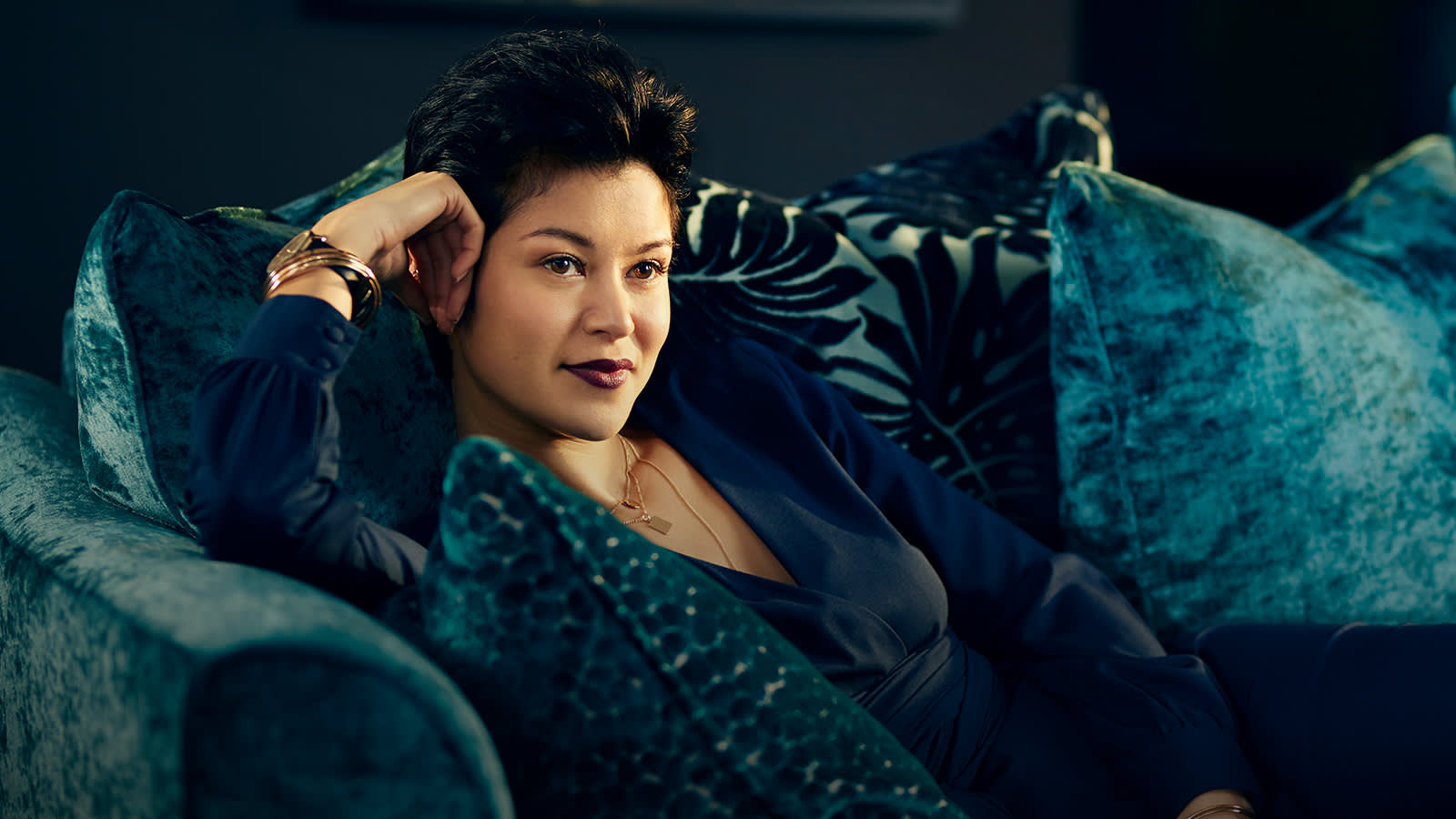 Woman relaxing on velvet Vivienne sofa range