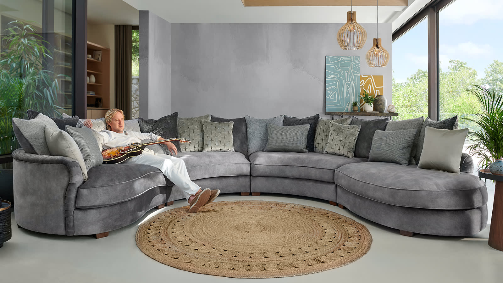 Owen Wilson sitting on the Sofology Palm sofa