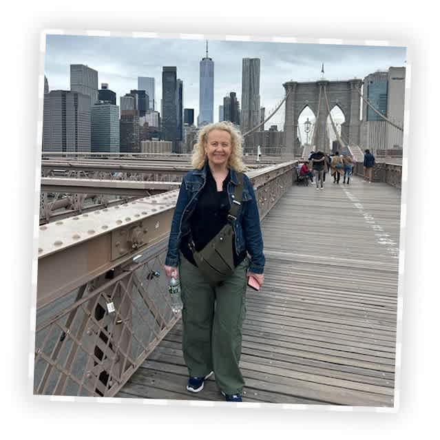 An image in a frame of a woman in New York, with skyscrapers behind her