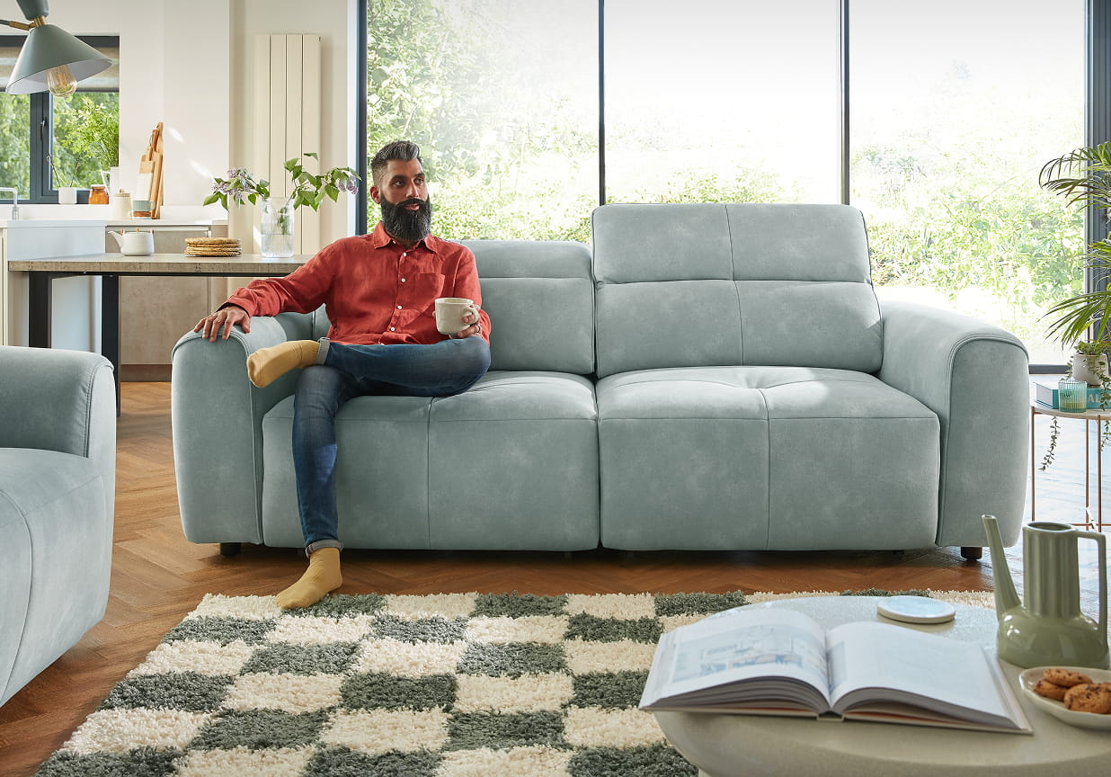 Man sitting on a grey sofa