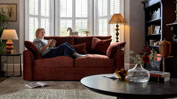 Woman sitting on a burgundy sofa