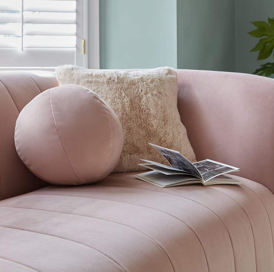 How do I clean spills and stains on a velvet sofa?