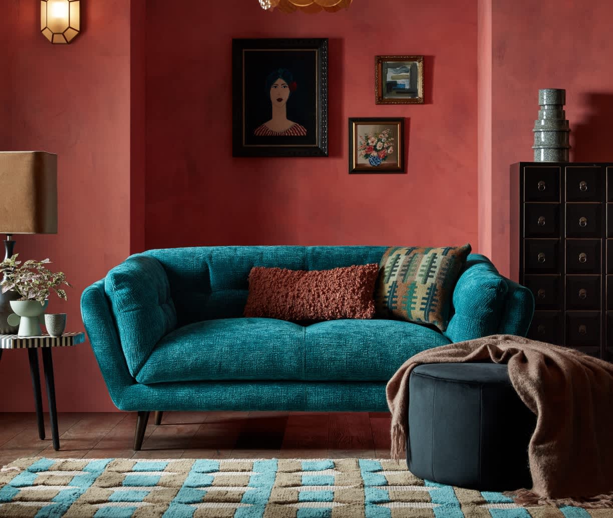Blue sofa in front of red walls in a room