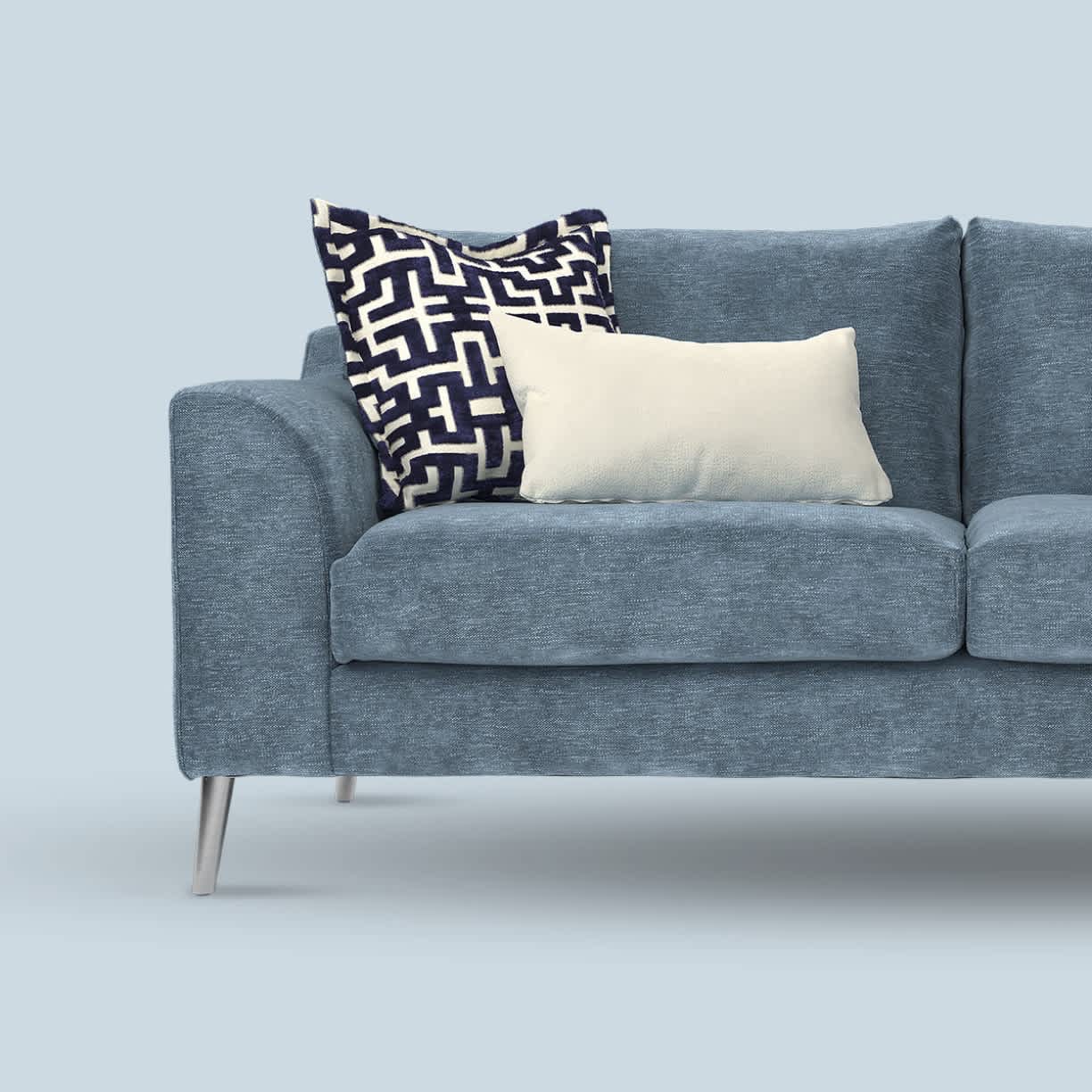 Light blue sofa with pillows on it